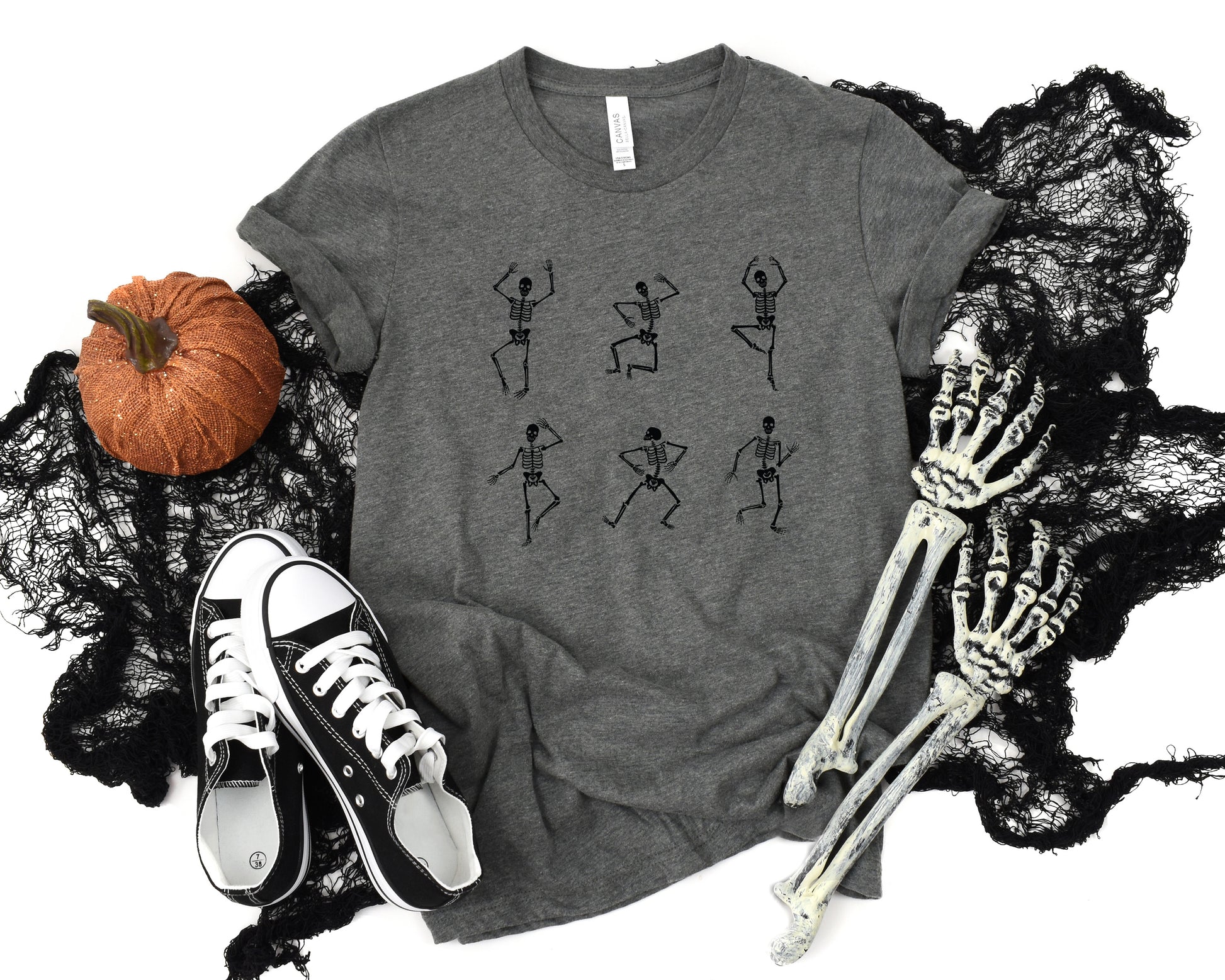 Adult graphic t-shirt featuring dancing skeletons design, unisex tee for Halloween or edgy style.