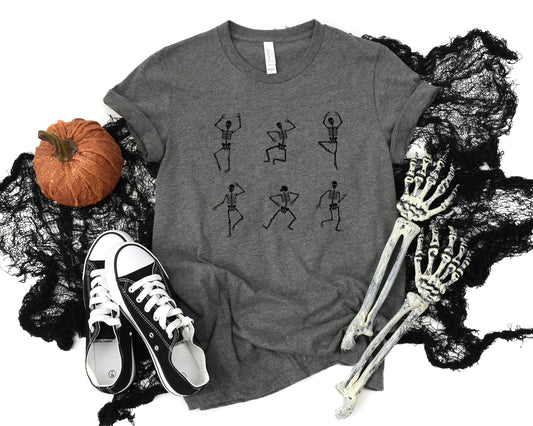 Adult graphic t-shirt featuring dancing skeletons design, unisex tee for Halloween or edgy style.