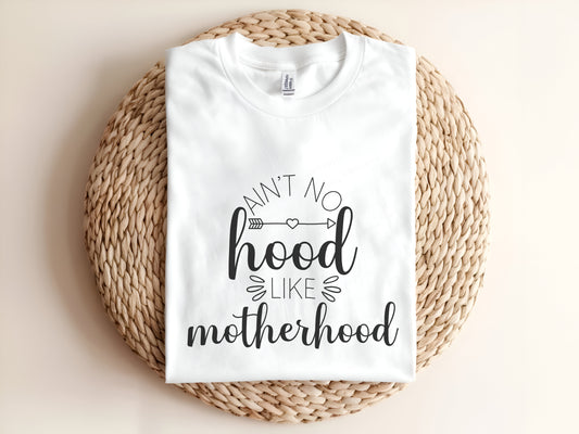Adult graphic t-shirt featuring “Ain’t No Hood Like Motherhood” slogan, funny unisex tee perfect for moms and casual everyday wear.