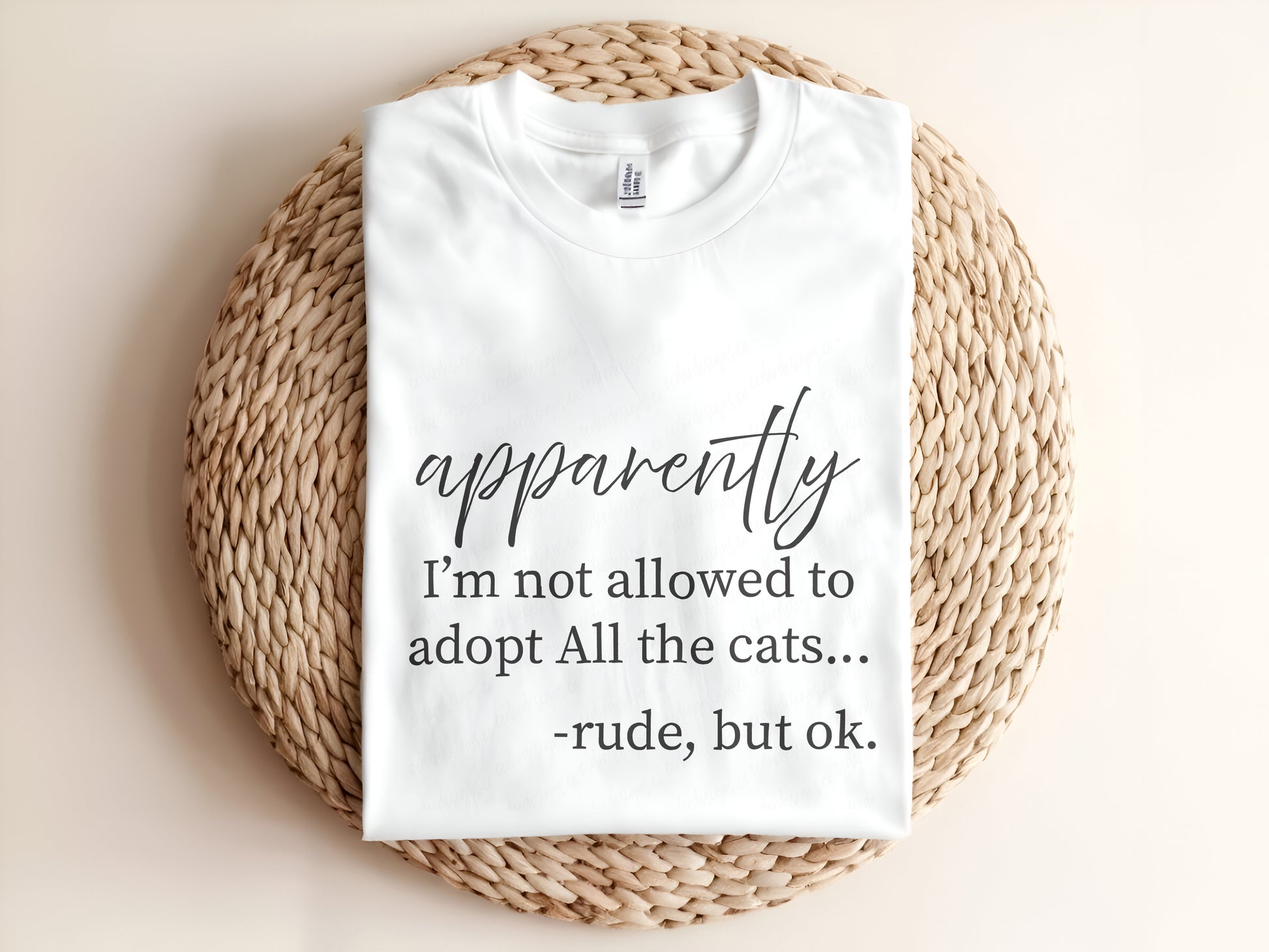 Adult graphic t-shirt featuring “Apparently I’m Not Allowed to Adopt All the Cats” slogan, funny unisex tee for cat lovers.